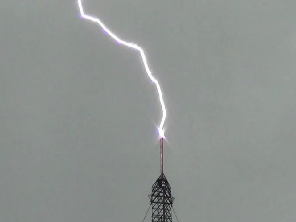 lightning striking the top of a 1,500 ft TV tower